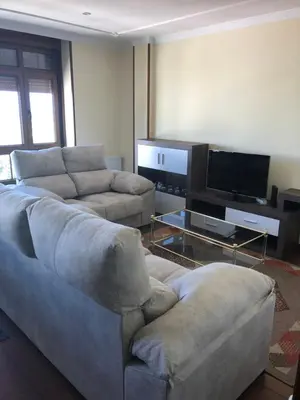 a living room with two couches and a flat screen tv at Apartamento Vistas al mar in Foz