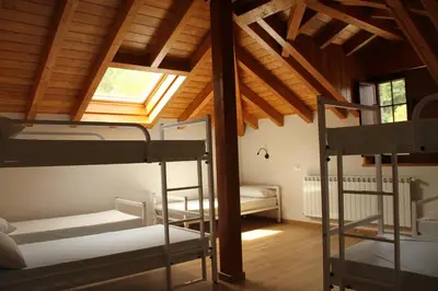 a room with three bunk beds and a window at Casa Lixa Hotel Rural Albergue in Las Herrerías
