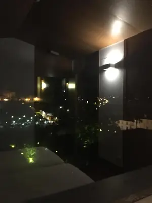 a room with a view of a city at night at Pensión O Xardin de Julia in Santiago de Compostela