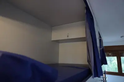 a bedroom with a bed with a blue canopy at Zendoira in Palas de Rei