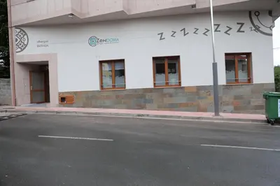 an empty street in front of a building at Zendoira in Palas de Rei