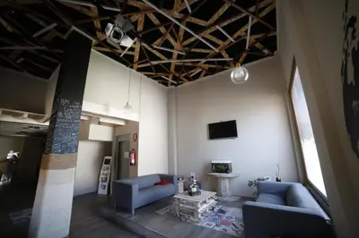 a living room with two blue couches and a tv at Zendoira in Palas de Rei