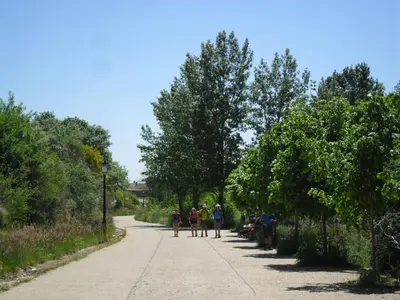 a group of people walking down a road at Posada El Tesin in Rabanal del Camino