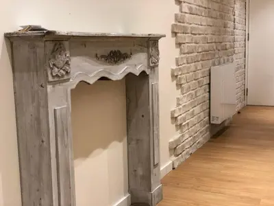a fireplace in a room with a brick wall at Rentxacobeo in Sarria