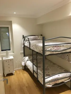 two bunk beds in a room with a window at Rentxacobeo in Sarria