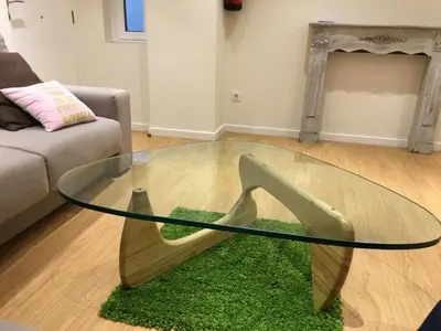 a glass coffee table with a pair of shoes on a rug at Rentxacobeo in Sarria