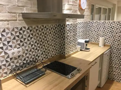 a kitchen with a counter with a sink and tiles at Rentxacobeo in Sarria