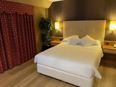 a bedroom with a large white bed and a window at Coto Real in Rábade