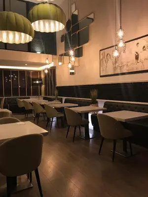 a dining room with tables and chairs and lights at Coto Real in Rábade