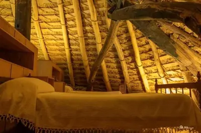 a bedroom with a bed in a stone wall at Palloza Baltasar in Castelo