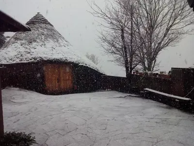 a house covered in snow in a yard at Palloza Baltasar in Castelo