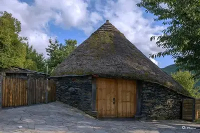 a small stone building with a thatched roof at Palloza Baltasar in Castelo