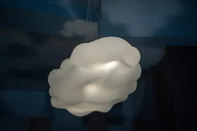 a white cloud light hanging from a ceiling at Blanco Albergue in Santiago de Compostela