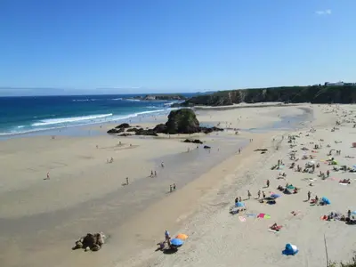 a large group of people on a beach at Hostal Restaurante Parajes in Castropol