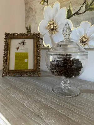 a glass jar filled with blackberries next to a picture at A Eira da Laxe in Cerdedo
