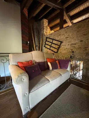 a couch with colorful pillows sitting in a room at A Eira da Laxe in Cerdedo