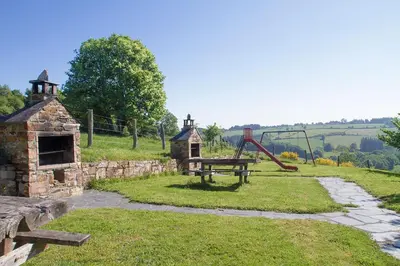 a park with a picnic table and a playground at Apartamentos rurales Vilarchao in Vilarchao