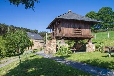 a small building in the middle of a field at Apartamentos rurales Vilarchao in Vilarchao
