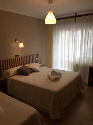 a bedroom with two beds with towels on them at Hotel Villa De Ribadeo in Ribadeo