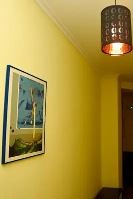 a picture of a windmill on a yellow wall at Hotel Villa De Ribadeo in Ribadeo