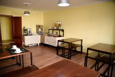 a room with two tables and a counter in a room at Hotel Villa De Ribadeo in Ribadeo