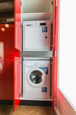 a washer and dryer in a red room at Casa Carla in Palas de Rei