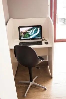 a desk with a laptop computer on top of it at De Camino in Arzúa