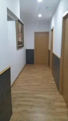 an empty hallway with wooden floors and doors at Monqar in Foz