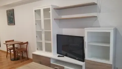 a living room with a tv and shelves at Monqar in Foz