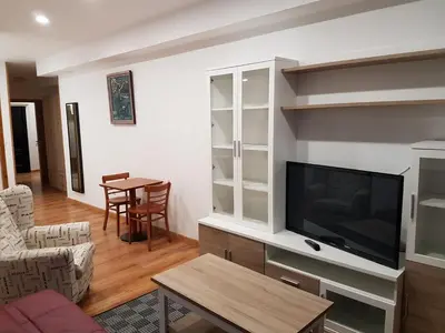 a living room with a tv and a table at Monqar in Foz