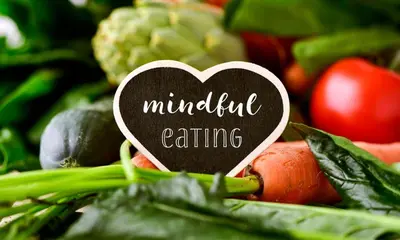 a heart shaped sign with the words mindfulness eating on top of vegetables at Pensión LO in O Pedrouzo
