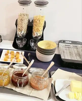 a table with jars of food and other foods at Pensión LO in O Pedrouzo