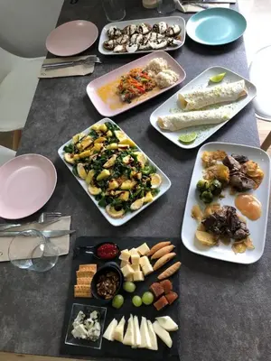 a table with many plates of food on it at Pensión LO in O Pedrouzo