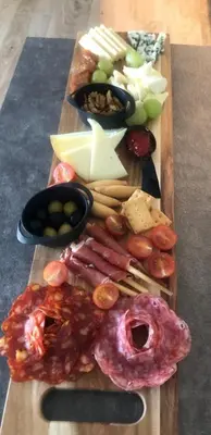 a cutting board with different types of food on it at Pensión LO in O Pedrouzo