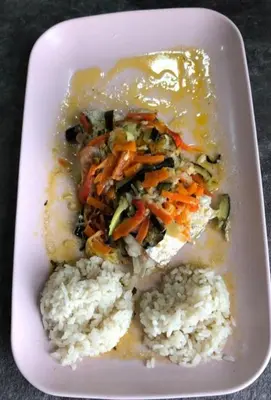 a white plate of food with rice and vegetables at Pensión LO in O Pedrouzo