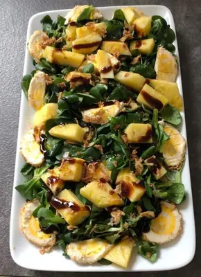 a white plate of food with potatoes and spinach at Pensión LO in O Pedrouzo