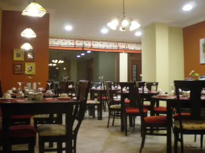 a dining room filled with tables and chairs at La Casona de Lazúrtegui in Ribadeo