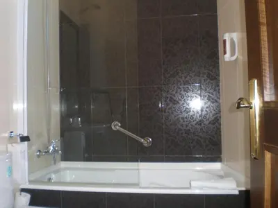 a bathroom with a shower with a bath tub at La Casona de Lazúrtegui in Ribadeo