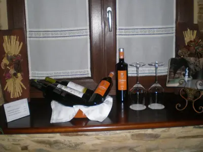 a table with bottles of wine and glasses on it at La Casona de Lazúrtegui in Ribadeo