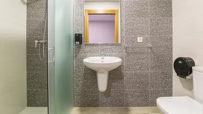a bathroom with a sink and a mirror at Pensión Pereiro in Melide