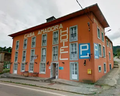 an orange building on the side of a street at Hotel Amadora - Admite mascotas in Barreiros