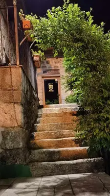 a set of stairs leading to a building with a door at Alcázar Milmanda in Milmanda