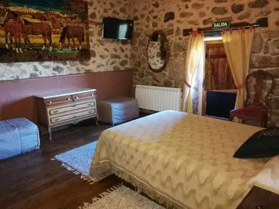 a bedroom with a bed and a dresser and a window at Alcázar Milmanda in Milmanda