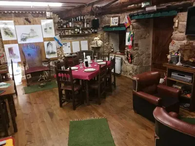 a restaurant with a table and chairs in a room at Alcázar Milmanda in Milmanda