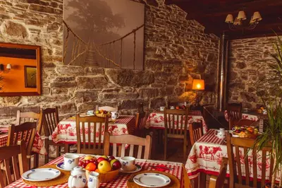 a restaurant with tables and chairs with fruit on them at Os Tres Teixos in San Acisclo