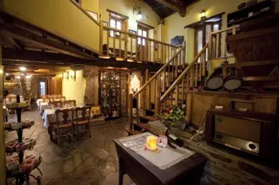 a large room with a table and a staircase at O Muiño de Pena in O Pino
