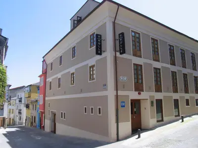 a large building on the side of a street at Hotel Rolle in Ribadeo