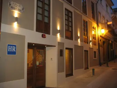 a building with a sign on the side of it at Hotel Rolle in Ribadeo