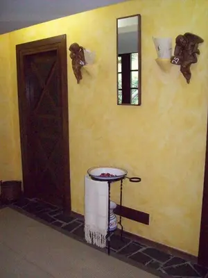 a room with a door and a table and a mirror at La Rectoral in Taramundi
