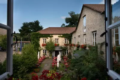 a view from a window of a building with flowers at A Quinta Da Auga Hotel Spa Relais & Chateaux in Santiago de Compostela